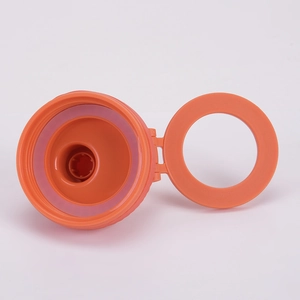 Detail of orange magnetic bottle lid with pink silicone leak-proof seal and handle