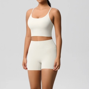 Front view of white high-waist yoga shorts and strappy U-neck crop top athletic set