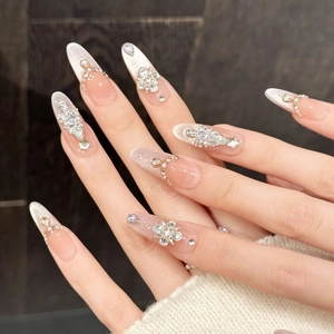 Detail of luxury pink ombre press-on nails with 3D floral crystals and pearls