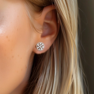 Macro side view of a model wearing the circular pave-set silver stud earring with crystals