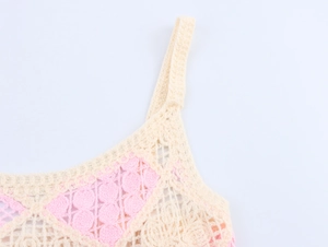 Detailed close-up of beige and pink crochet hollow-out pattern on knit camisole