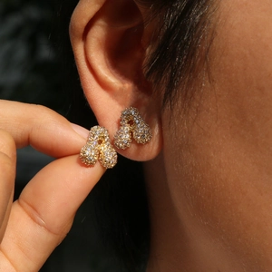 Chic 18k gold plated bubble letter earrings with sparkling cubic zirconia on model
