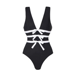 Detail of one-piece swimsuit featuring V-neckline with decorative white bows and cut-outs