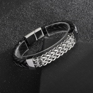 Detail of black braided leather and silver stainless steel chain bracelet with magnetic clasp