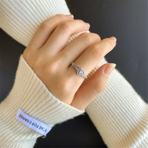 Close-up of luxury silver-colored knotted ring with sparkling micro-pave crystals