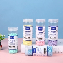 Colorful laundry fragrance beads in a transparent bottle for clothing fresh scent