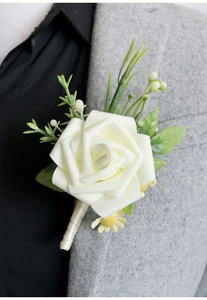 Elegant white faux rose boutonniere on grey suit lapel for wedding and prom events