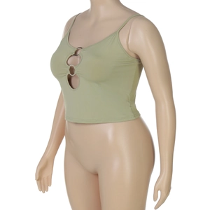 Detail of green crop top featuring multiple ring cut-outs and slim fit knitted fabric