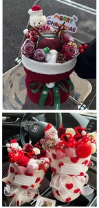 Close-up of a Christmas gift basket with red roses and apple in stylish tweed wrap