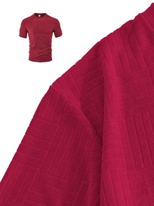Detailed macro view of dark red waffle textured fabric on a men's short-sleeve polo shirt