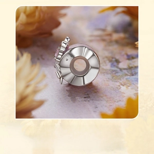 Macro shot of S925 sterling silver dragonfly charm with detailed engraving and hallmark