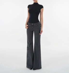 Full body shot of a model in a black slim fit t-shirt and grey cargo flare jeans