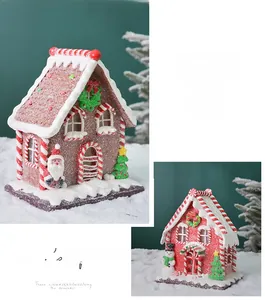 Detailed view of two light-up gingerbread houses with snow-covered roofs and festive figures