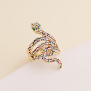 Luxurious gold-plated snake ring with colorful zircon stones on a geometric background