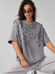Detail of vintage washed cotton T-shirt featuring rhinestones H pattern on dark gray