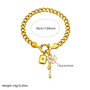 Gold chain bracelet with star pendant and crystal clover charm featuring T-bar clasp