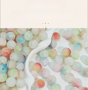 Macro shot of 10mm marbled glass beads with gold foil for DIY jewelry making