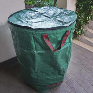 Detailed close-up of a large green garden waste bag with zipper lid and striped handles
