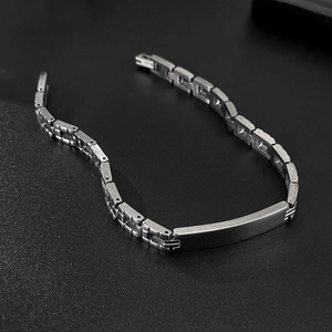 Macro shot of polished silver stainless steel ID bar bracelet with a brushed metal finish
