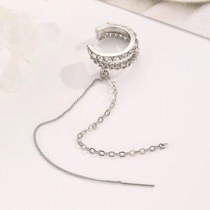 Detail view of silver ear bone clip with double-row crystals and hanging tassel chains