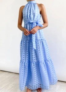 Detail of light blue plaid sleeveless dress with halter neck and tiered cake skirt