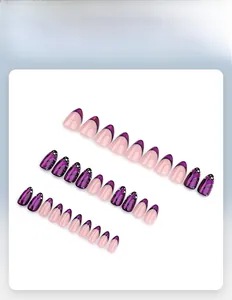 Detail view of butterfly pattern press-on nail set with purple French tips and glitter
