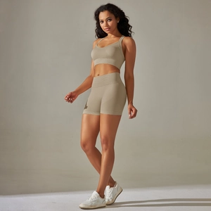 Detail of seamless ribbed knit texture on high waist yoga shorts and matching sports bra