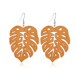Bohemian hollow monstera leaf wood earrings with natural brown grain and silver hooks