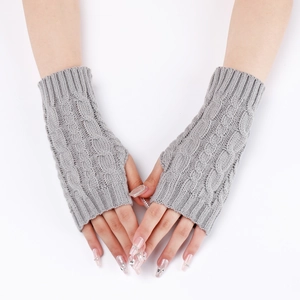 Detail of grey cable knit fingerless arm warmers showing soft wool texture on a model