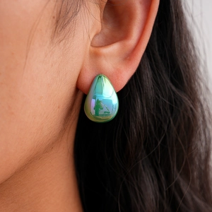 Detail showing iridescent green teardrop earring with high glossy finish on ears