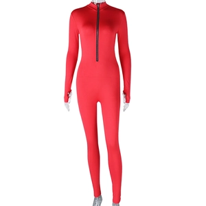 Detailed front view of a red high-stretch jumpsuit with a long front zipper and thumb holes