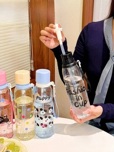 Detail of pink cartoon straw cup featuring panda pattern and Fashion in Cup text design