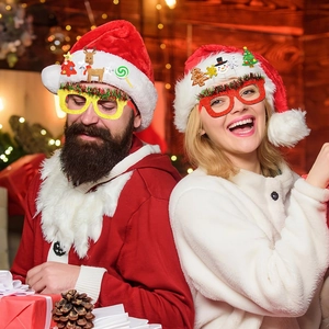 Adult and kids wearing glitter Christmas glasses frames with reindeer and snowman decor