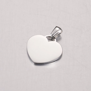 Polished mirror finish stainless steel heart pendant with clasp on brushed metal surface