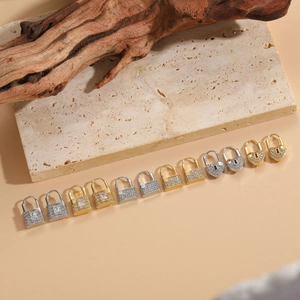 Macro shot of 14K gold plated heart and square lock earrings with micro-set zircon