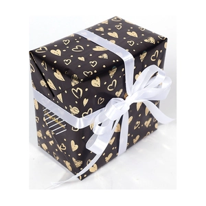 Large black gift wrapping paper with gold heart patterns and a white satin ribbon bow