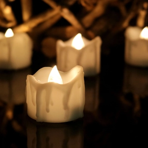 Realistic LED flickering candles with warm yellow light and dripping wax effect for decor