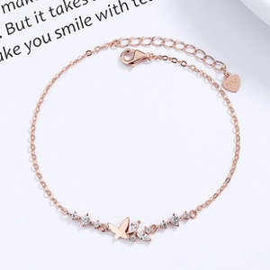 Detailed macro view of rose gold butterfly bracelet with shimmering diamond inlay accents