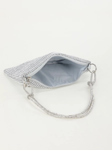 Detailed view of the silver rhinestone evening bag showing the blue satin lining and pocket