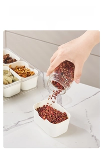 Close-up of clear spice box with removable dividers and large opening for kitchen storage