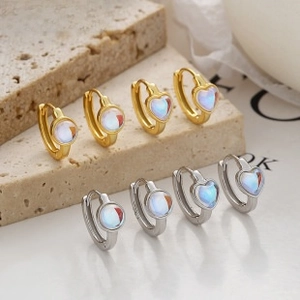 Detailed shot of 925 sterling silver evil eye heart hoop earrings in gold and silver