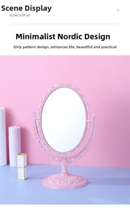 Close-up of pink vintage oval makeup mirror with ornate carvings and adjustable stand
