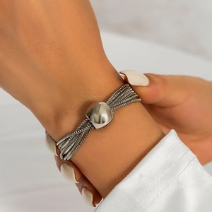 Close-up of silver layered chain bracelet with minimalist square metal buckle on wrist