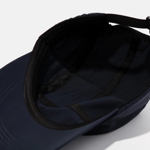 Detail view of the interior sweatband and stitching on the navy quick-dry baseball cap