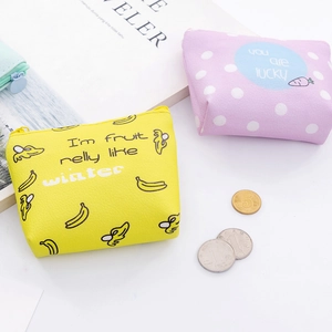 Close-up of yellow banana and purple polka dot PU leather mini coin purses with zipper