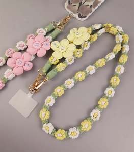 Handmade woven daisy phone strap featuring pink and yellow flowers with SMILE text