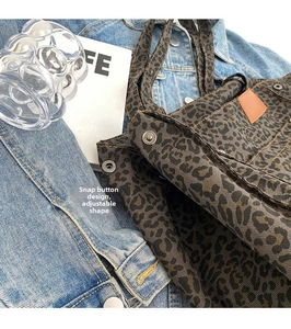 Detailed close-up of leopard print canvas tote with adjustable side snap button