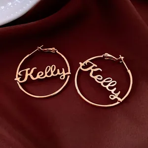 Custom 18K rose gold plated hoop earrings featuring cursive Kelly name on red velvet