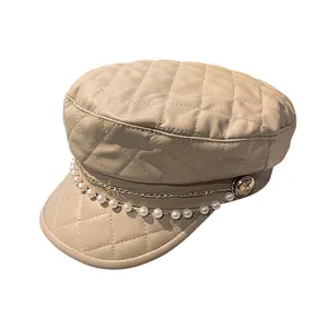 Elegant beige quilted leather newsboy cap with pearl and gold chain detail