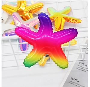 Close-up of laser starfish hair clips with rainbow gradient sequins and metal grip